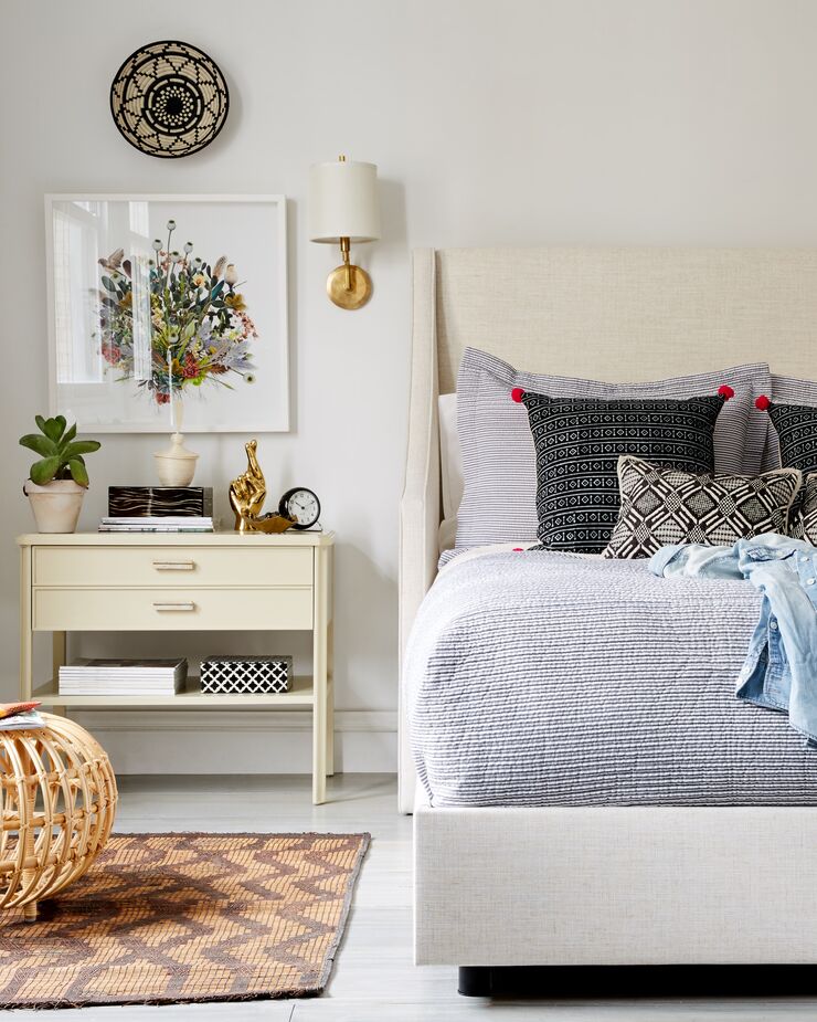 Although it requires a box spring, the Davis Wingback Bed has the low-slung appearance of a platform bed, albeit one with a high (and well-padded) headboard. Find the ottoman here and a similar sconce here.
